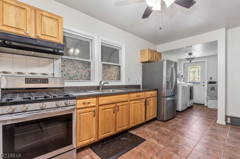 213 Linden Road, Unit 213 Roselle, NJ 07203 - Photo 10 of 14 a kitchen with stainless steel appliances granite countertop a stove and a refrigerator