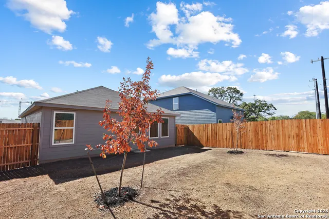 a view of a house with wooden fence
