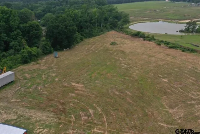 an aerial view of a house with a yard and lake view