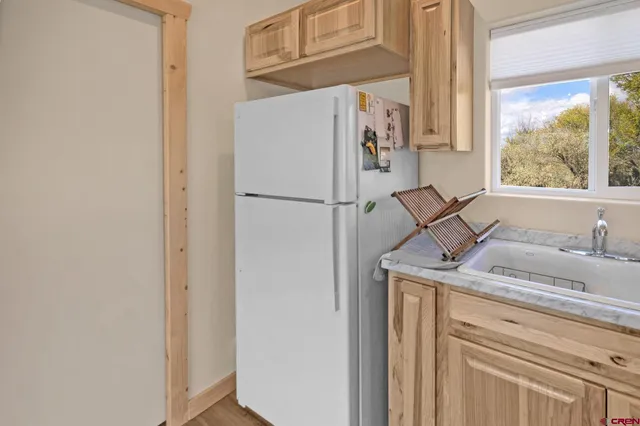 a white refrigerator freezer sitting inside of a kitchen