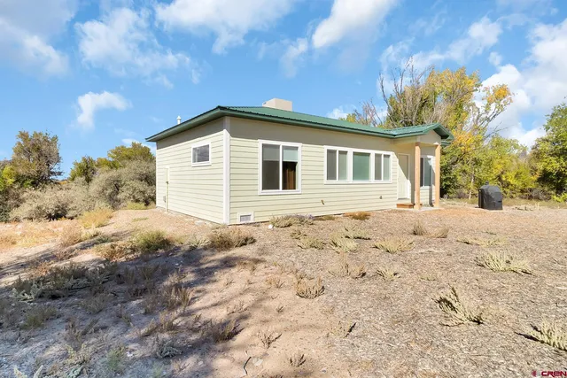 a view of a house with a yard covered with snow