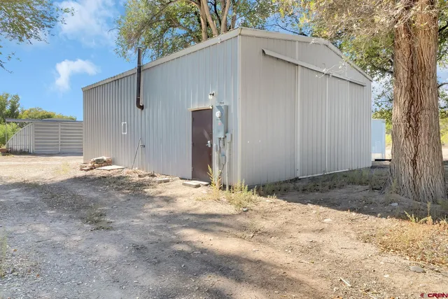 a view of a lake with a bench and trees