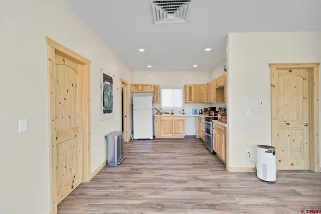 a view of a kitchen with wooden floor