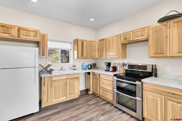 a kitchen with a sink a stove and refrigerator