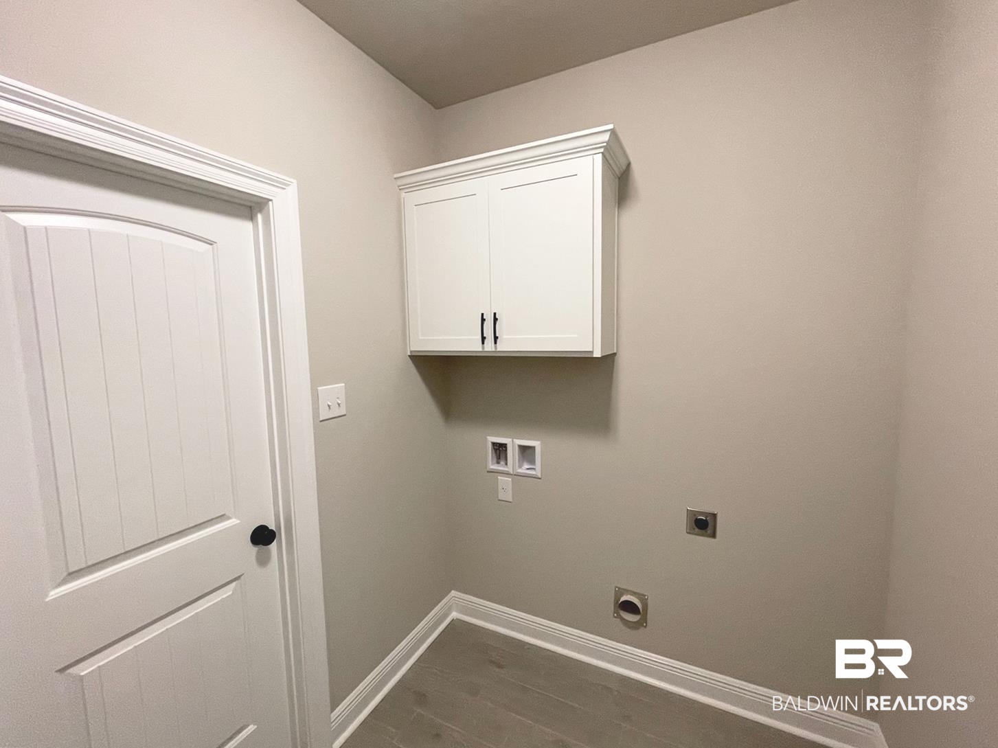 1634 Fenton Circle Foley, AL 36535 - Photo 11 of 14 Laundry area with cabinets, electric dryer hookup, wood-type flooring, and washer hookup