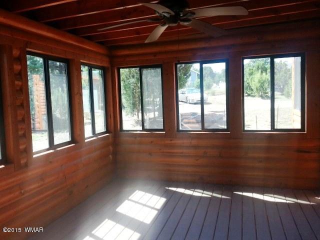 3238 Lodgepole Road Overgaard, AZ 85933 - Photo 5 of 7 a view of empty room with wooden floor and fan