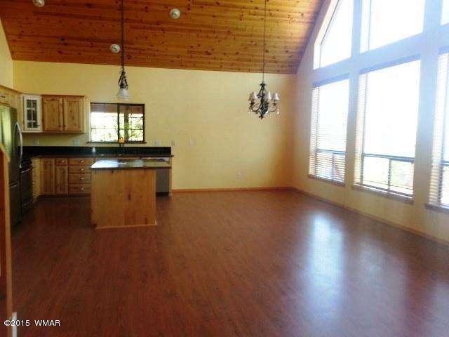 3238 Lodgepole Road Overgaard, AZ 85933 - Photo 6 of 7 a view of empty room with wooden floor and fan