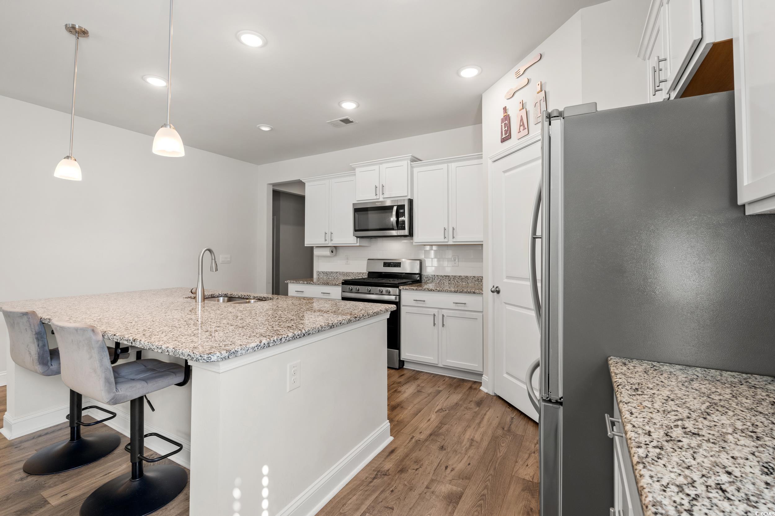 1087 Baker Creek Loop Myrtle Beach, SC 29579 - Photo 15 of 37 Kitchen featuring wood finished floors, stainless
