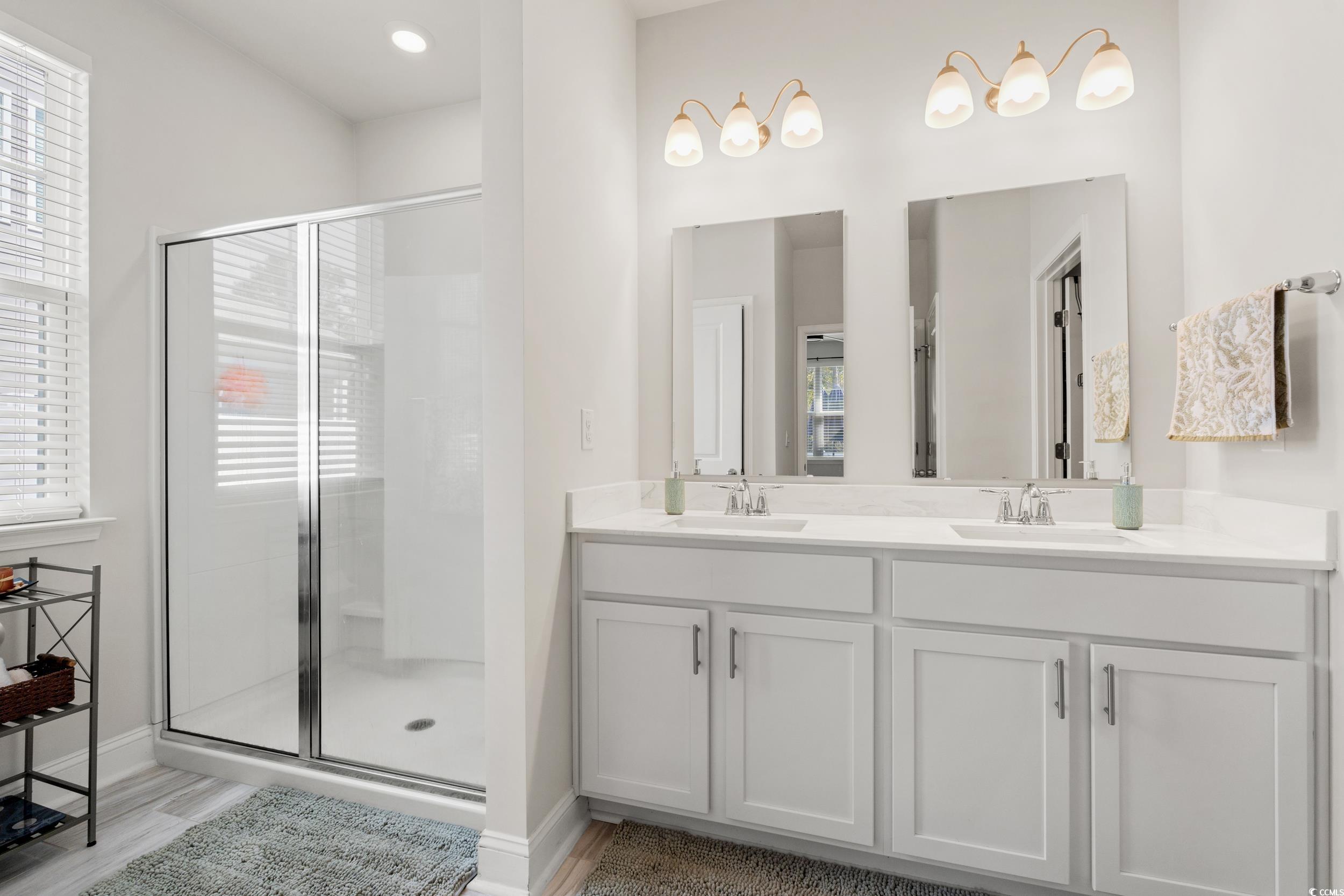 1087 Baker Creek Loop Myrtle Beach, SC 29579 - Photo 18 of 37 Bathroom featuring baseboards, a shower stall, and