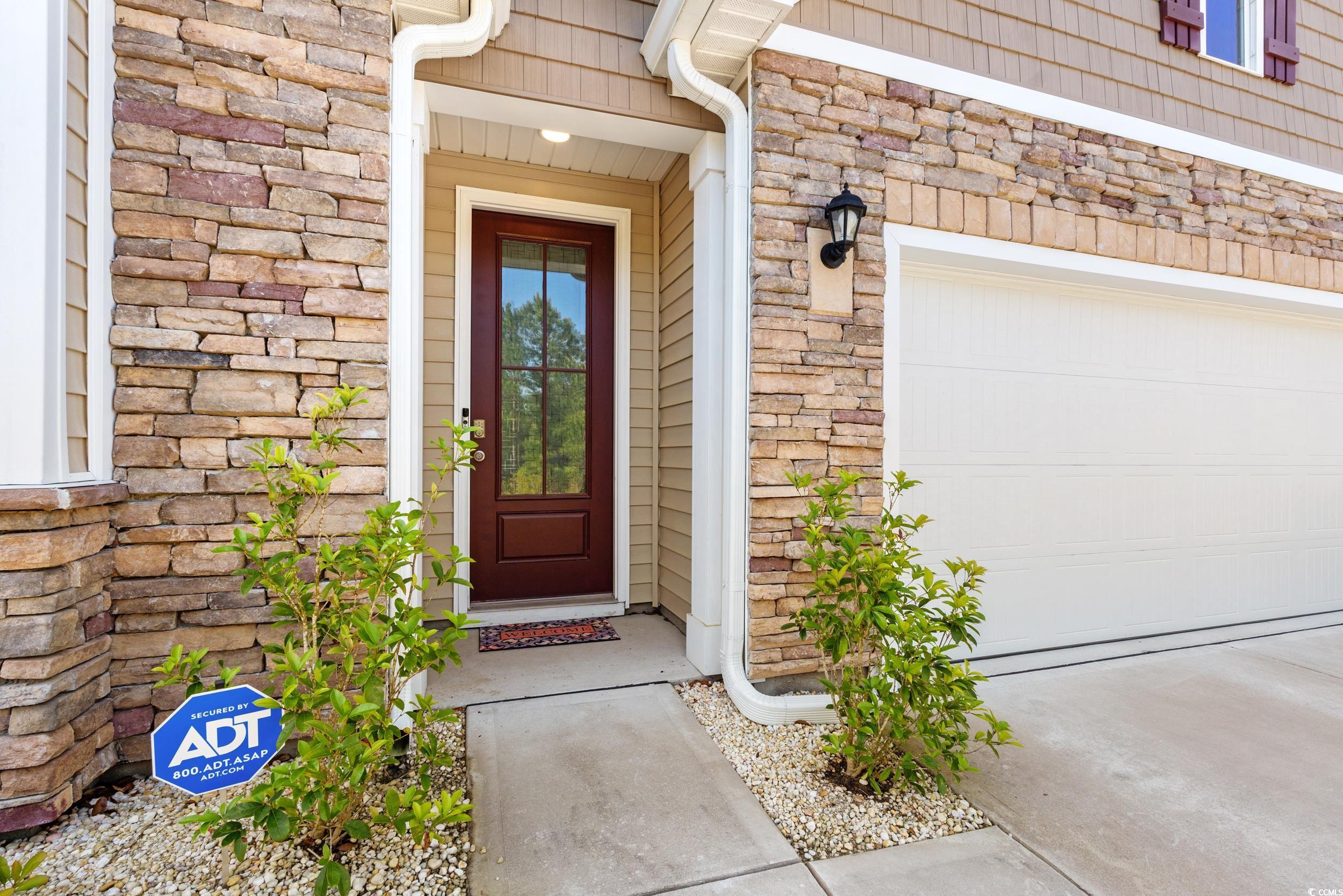 1087 Baker Creek Loop Myrtle Beach, SC 29579 - Photo 8 of 37 Doorway to property featuring a garage