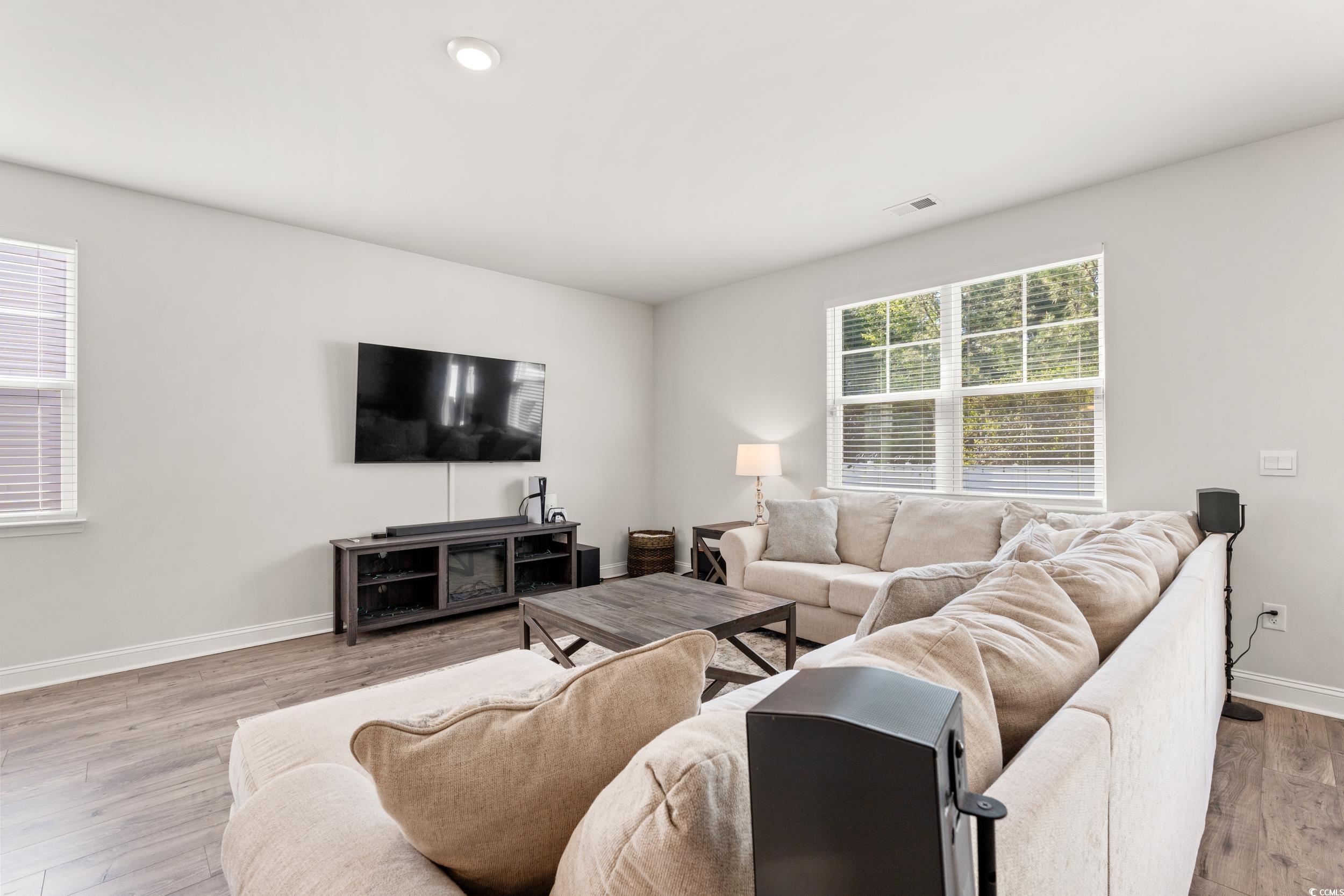 1087 Baker Creek Loop Myrtle Beach, SC 29579 - Photo 10 of 37 Living room with baseboards, visible vents, and wo
