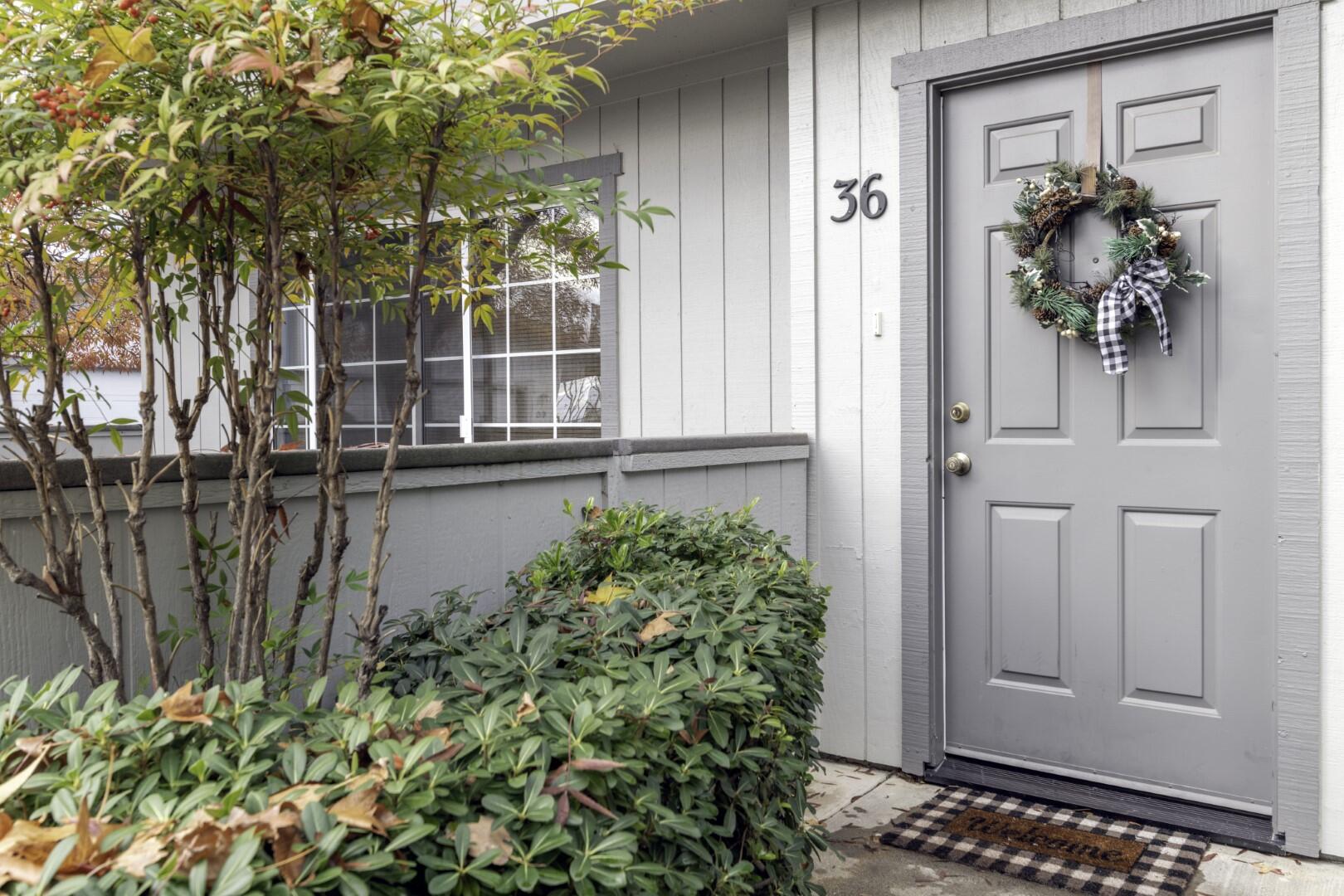 front view of a house with a potted plant