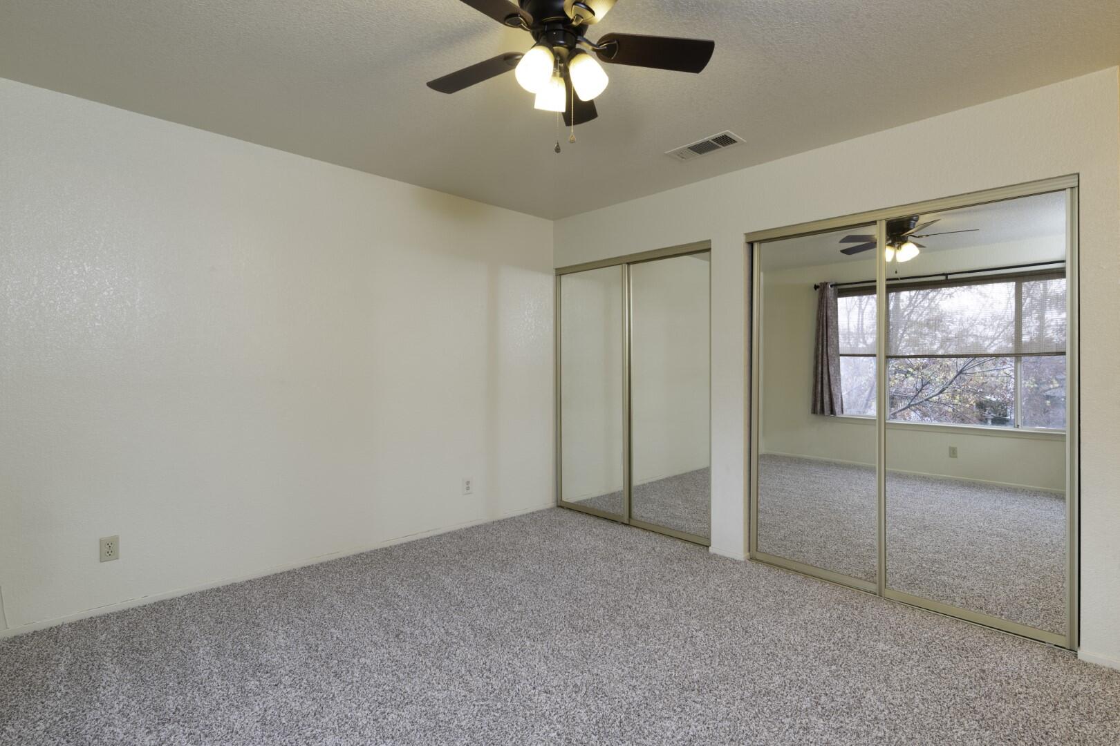 200 Ridgetop Drive, Unit 36 Redding, CA 96003 - Photo 14 of 24 an empty room with chandelier fan and windows