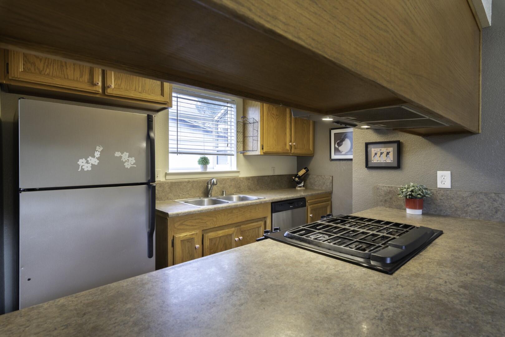 200 Ridgetop Drive, Unit 36 Redding, CA 96003 - Photo 7 of 24 a kitchen with stainless steel appliances granite countertop a refrigerator stove and sink