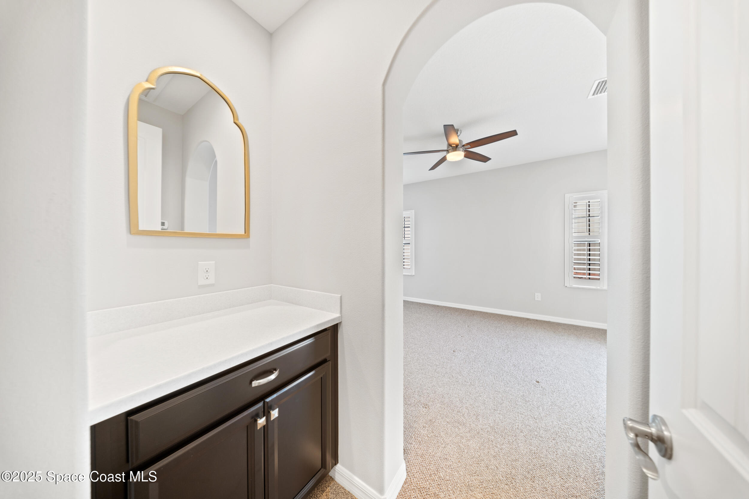 8830 Napolo Drive Melbourne, FL 32940 - Photo 11 of 36 a view of a hallway with a sink