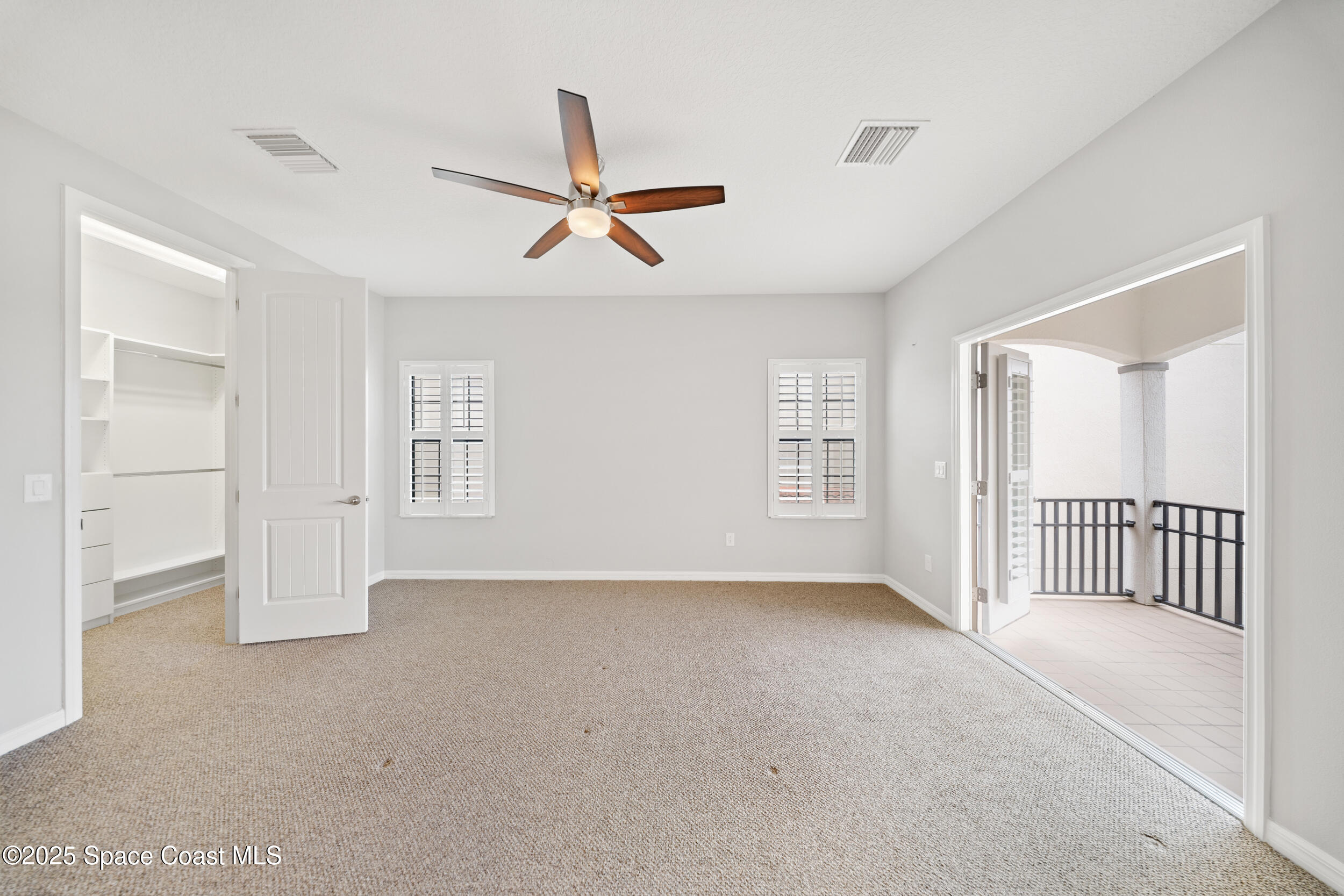 8830 Napolo Drive Melbourne, FL 32940 - Photo 13 of 36 a view of a livingroom with a ceiling fan and window
