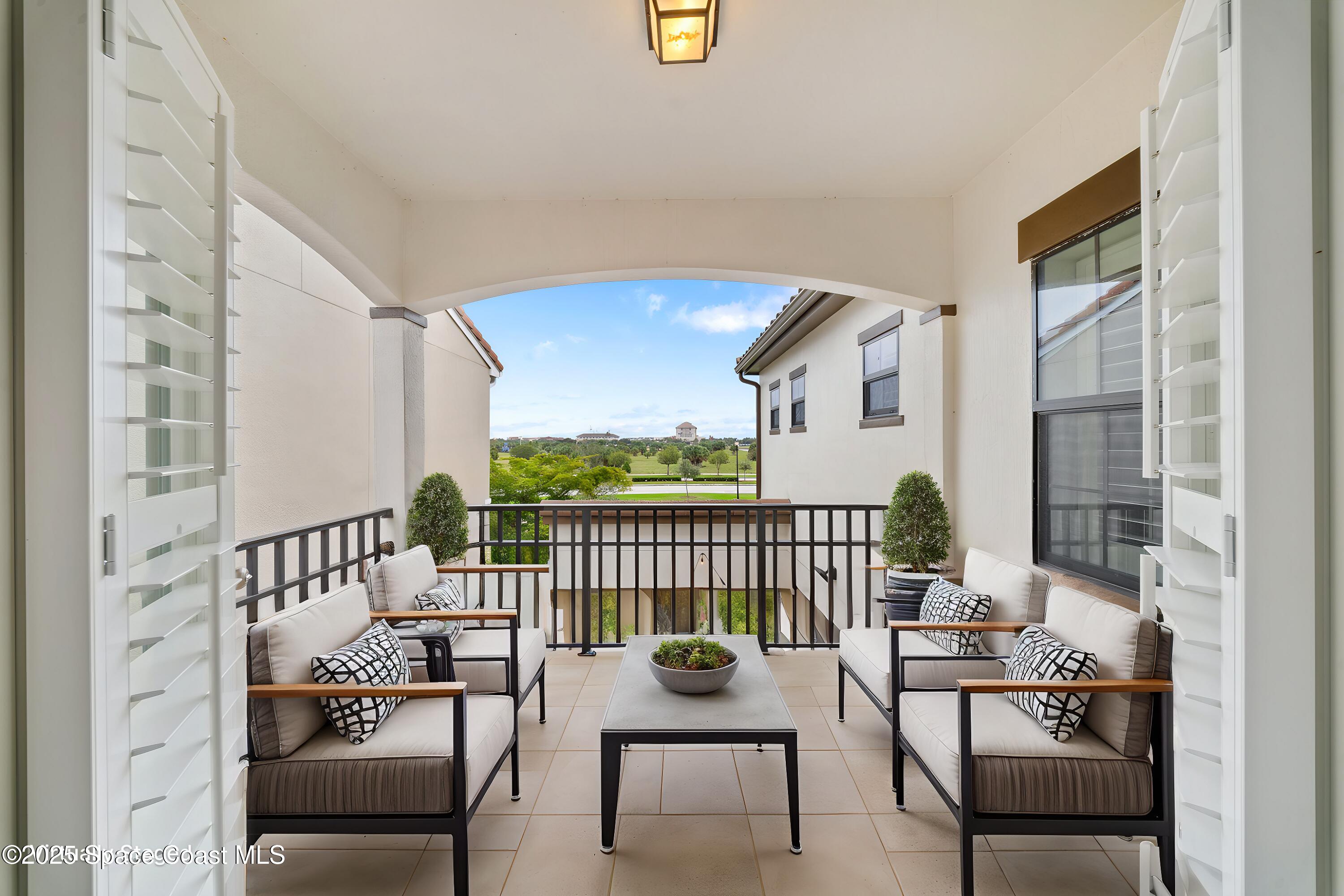 8830 Napolo Drive Melbourne, FL 32940 - Photo 14 of 36 a view of a balcony with chairs