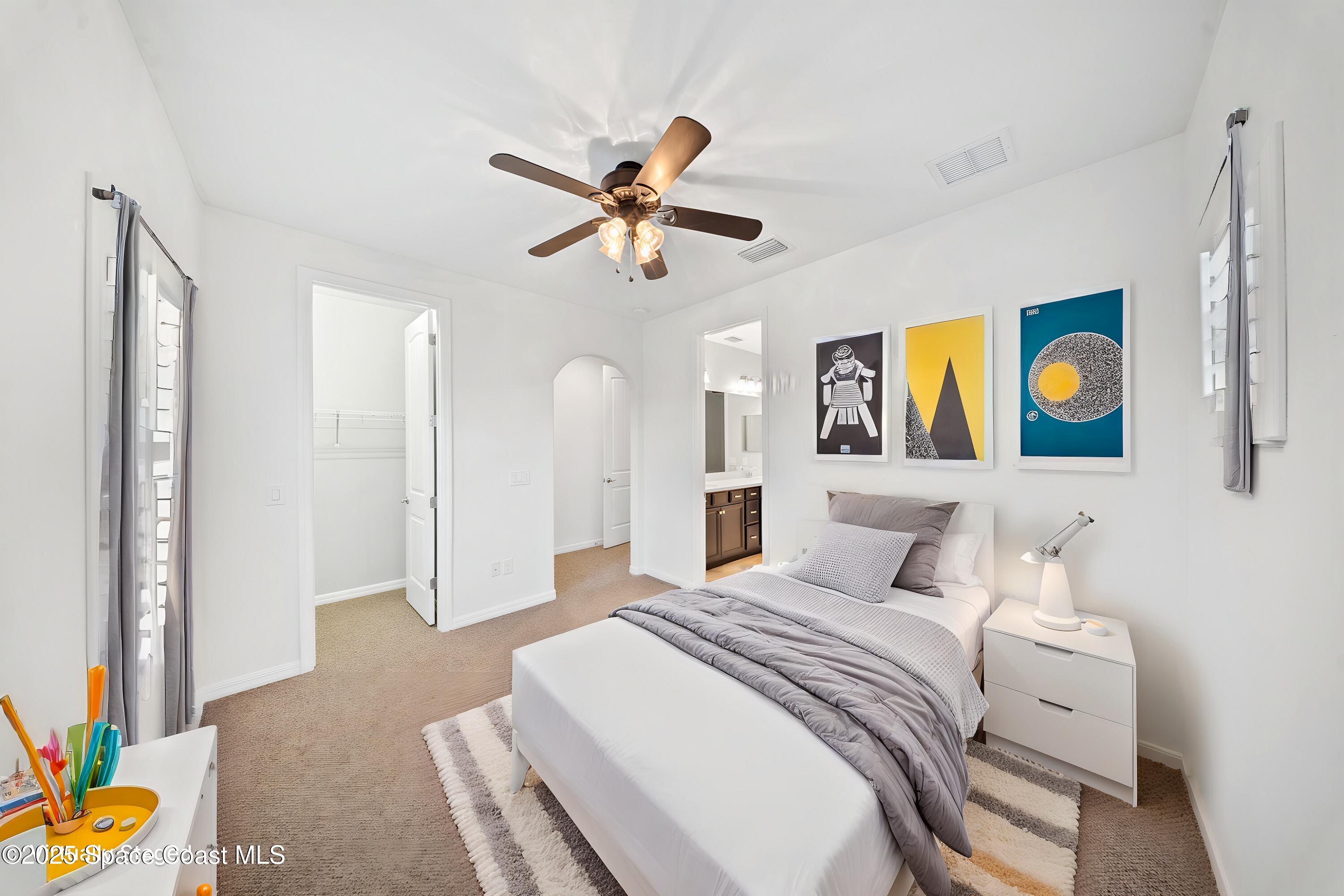 8830 Napolo Drive Melbourne, FL 32940 - Photo 19 of 36 a bedroom with a bed and painting on the wall