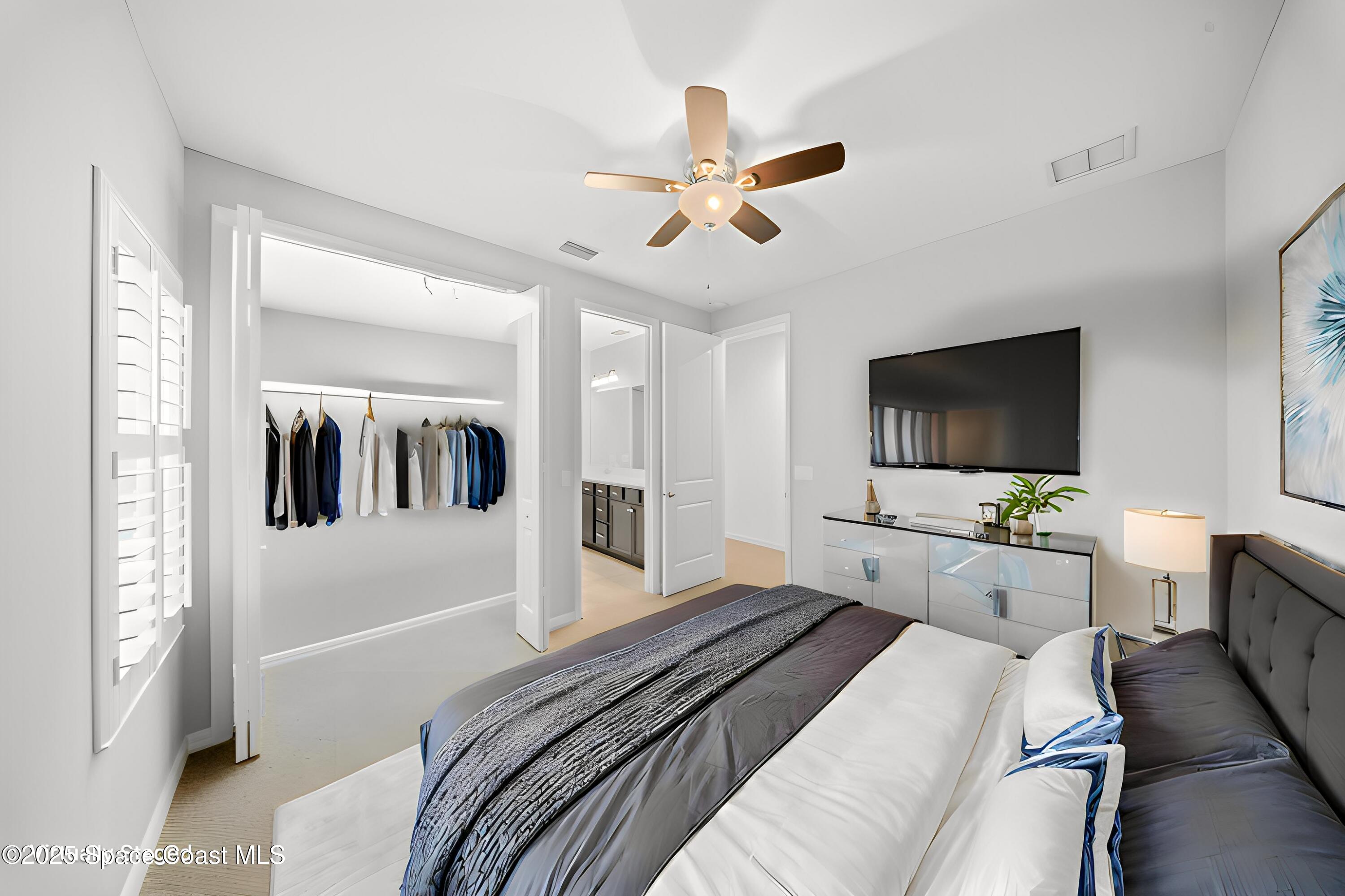 8830 Napolo Drive Melbourne, FL 32940 - Photo 20 of 36 a bedroom with a bed and a flat screen tv