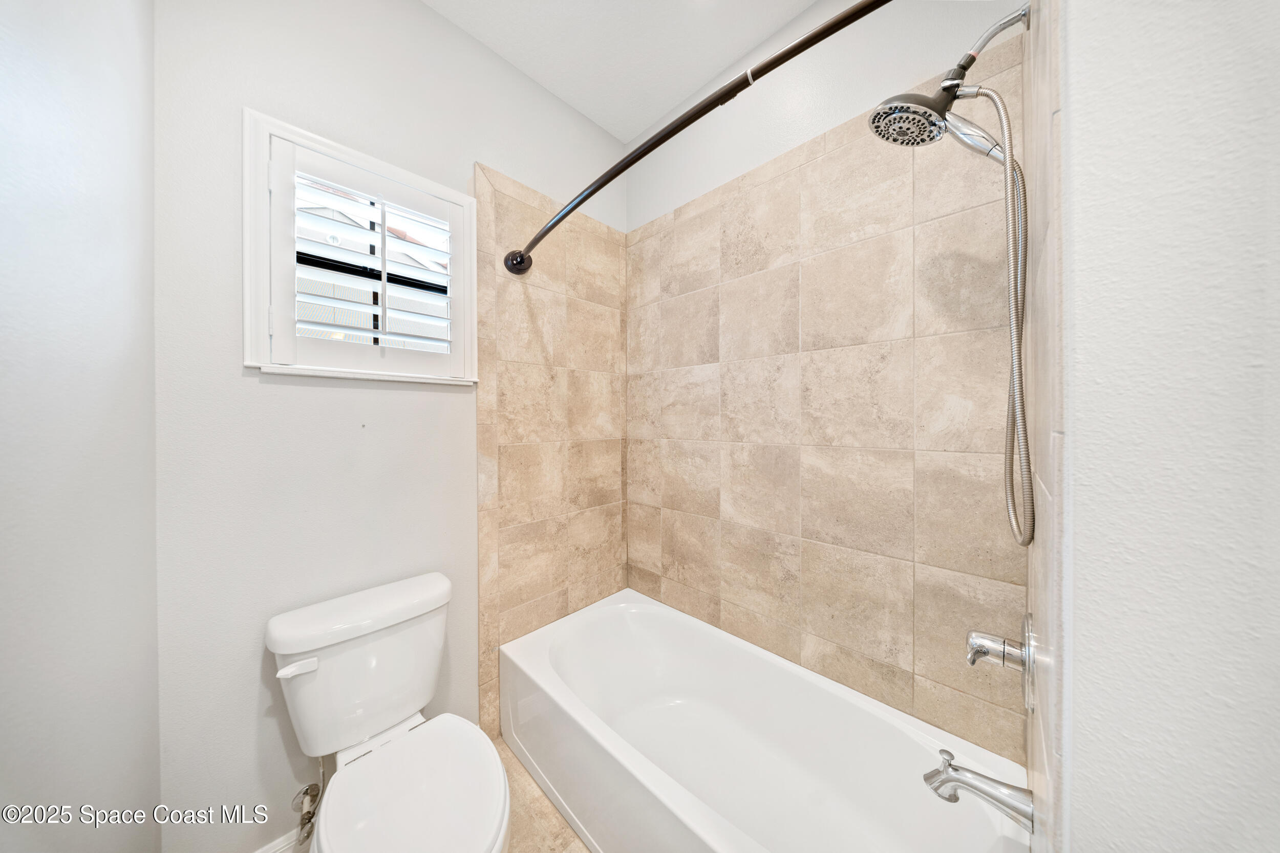 8830 Napolo Drive Melbourne, FL 32940 - Photo 22 of 36 a bathroom with a toilet and a bathtub