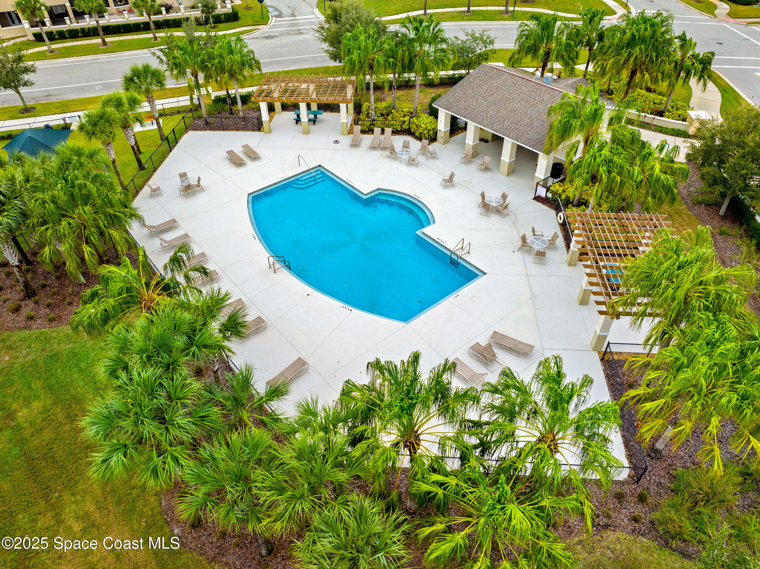 8830 Napolo Drive Melbourne, FL 32940 - Photo 34 of 36 an aerial view of a house with yard and swimming pool