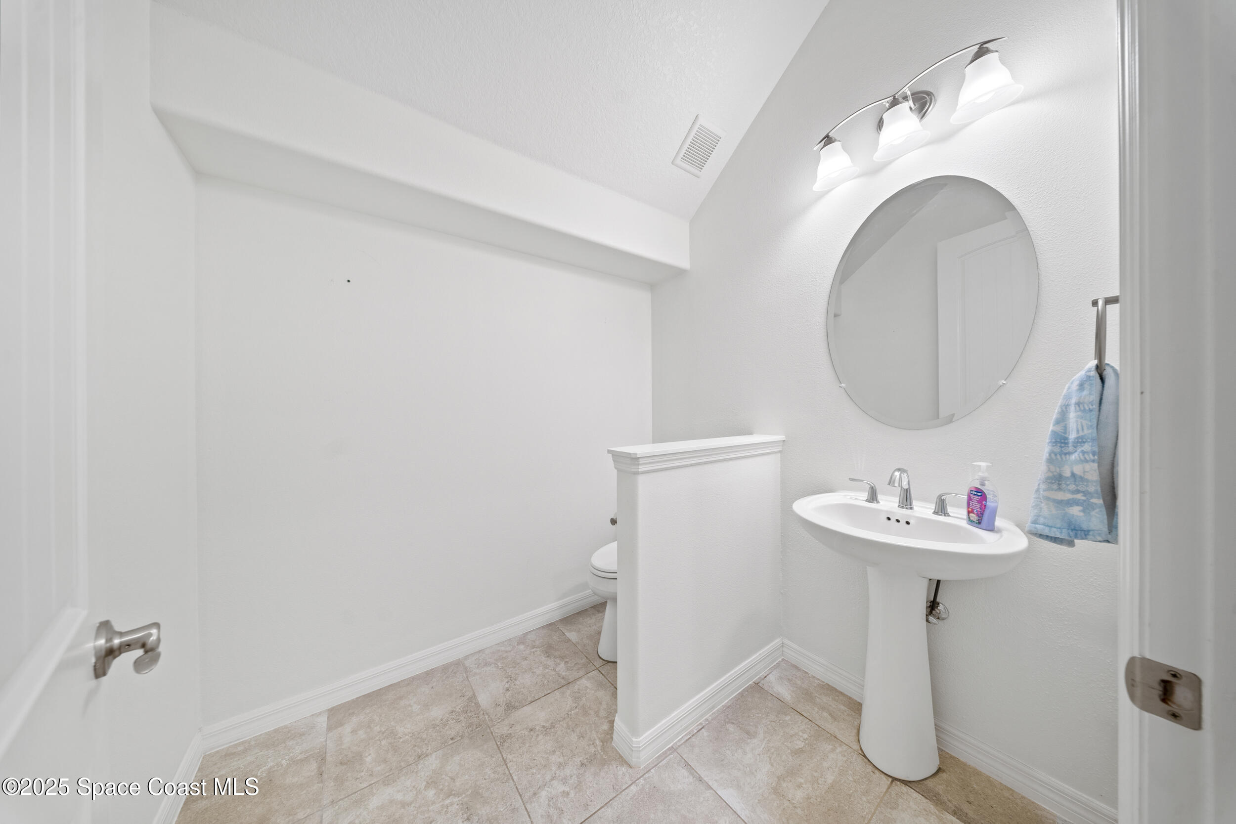 8830 Napolo Drive Melbourne, FL 32940 - Photo 7 of 36 a bathroom with a sink and a mirror