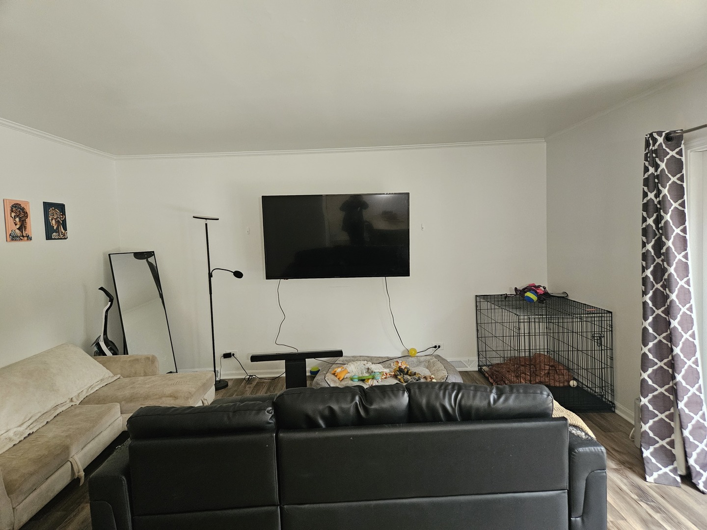 4-n055 Robbie Lane Addison, IL 60101 - Photo 4 of 9 a living room with a couch and a flat screen tv