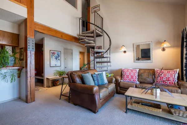 a living room with furniture and a potted plant