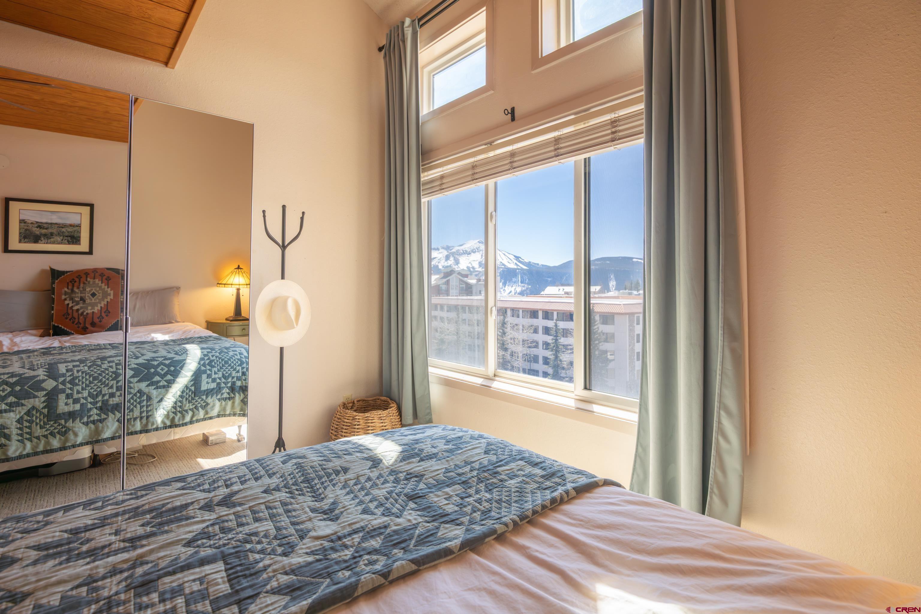 25 Emmons Road, Unit 41 Crested Butte, CO 81225 - Photo 17 of 45 a bedroom with a bed and wooden floor