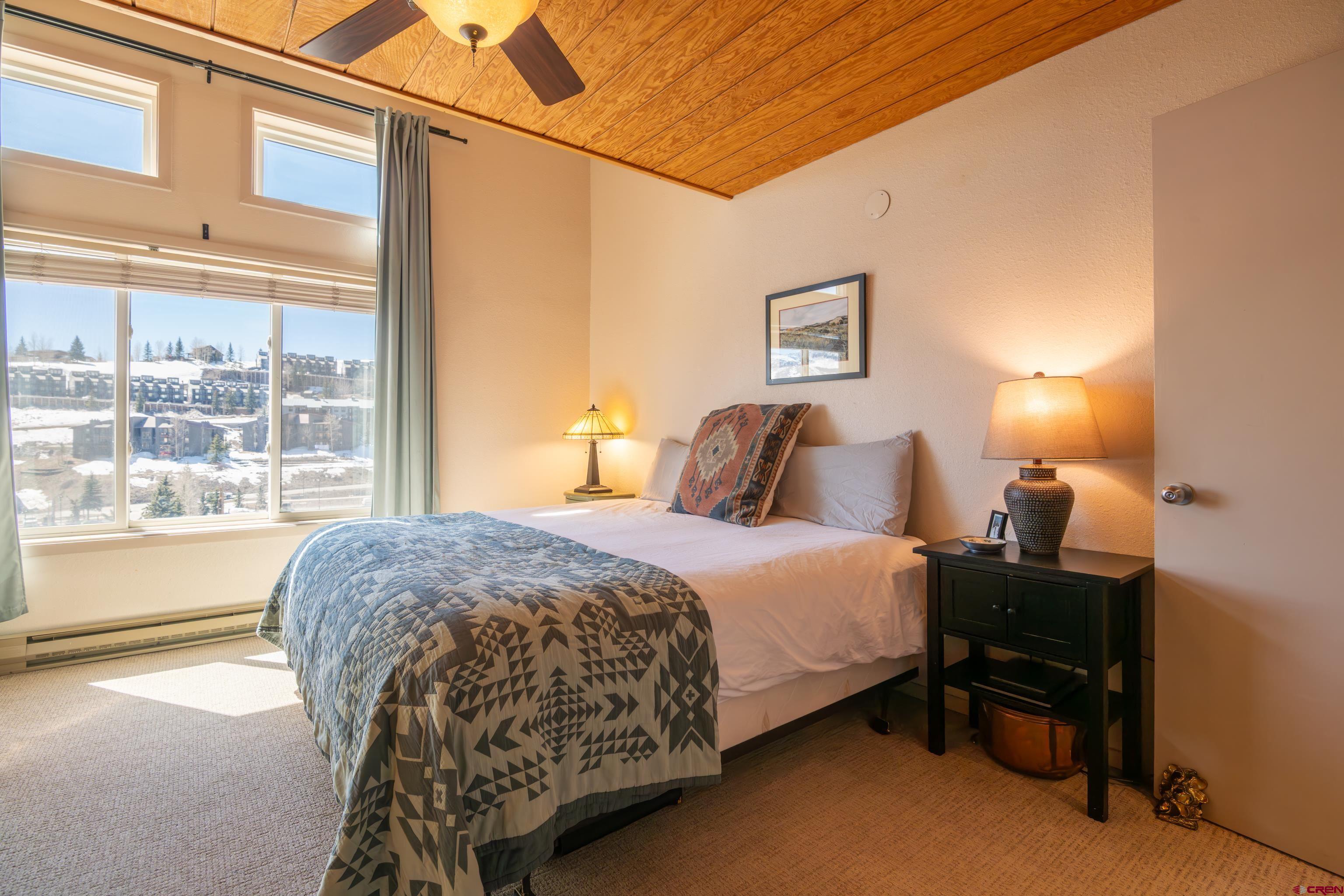 25 Emmons Road, Unit 41 Crested Butte, CO 81225 - Photo 22 of 45 a bedroom with a bed and a large window