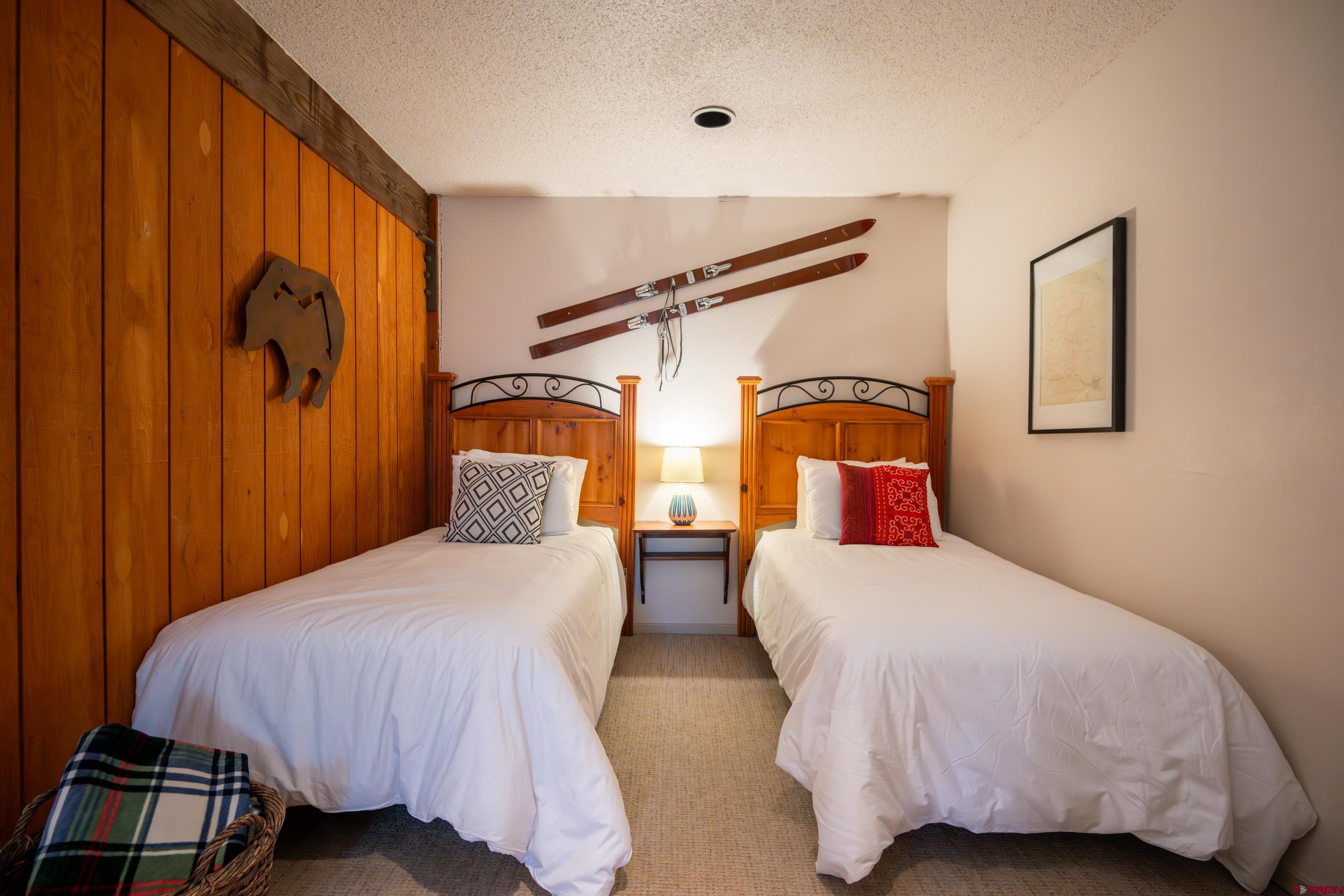 25 Emmons Road, Unit 41 Crested Butte, CO 81225 - Photo 29 of 45 a bedroom with two beds and painted walls