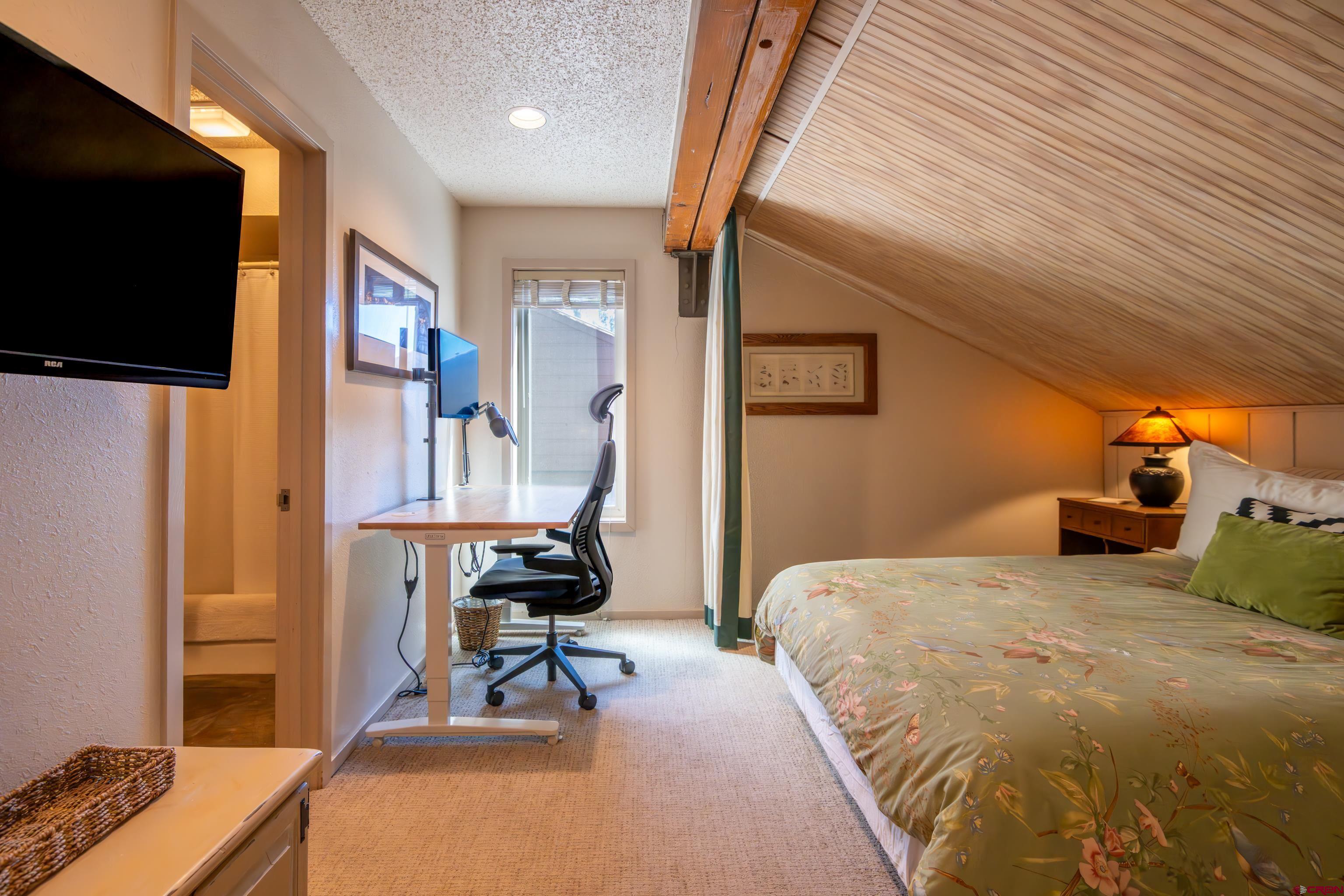 25 Emmons Road, Unit 41 Crested Butte, CO 81225 - Photo 31 of 45 a bedroom with a bed and a flat screen tv