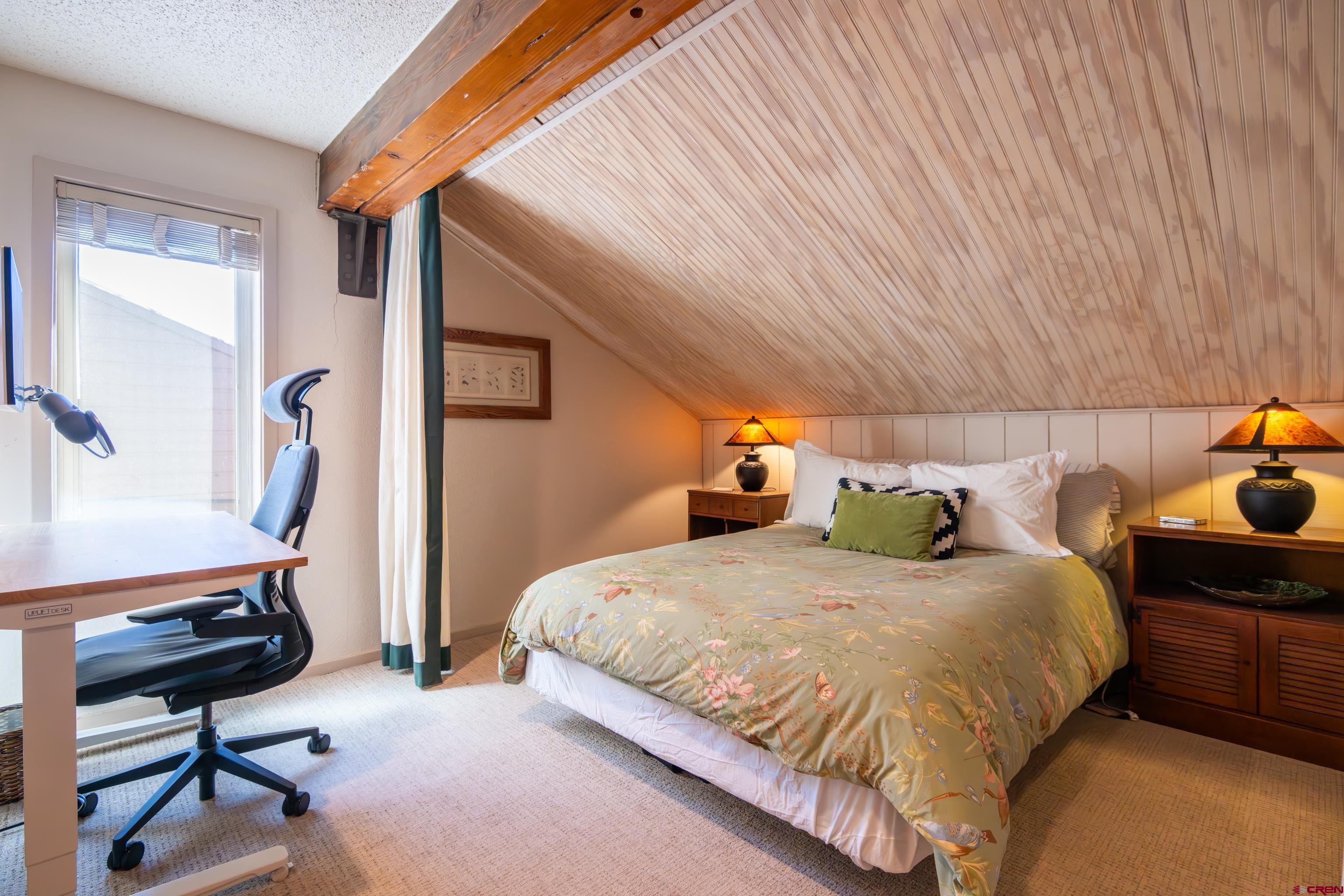 25 Emmons Road, Unit 41 Crested Butte, CO 81225 - Photo 32 of 45 a bedroom with a bed a desk and chair with rug