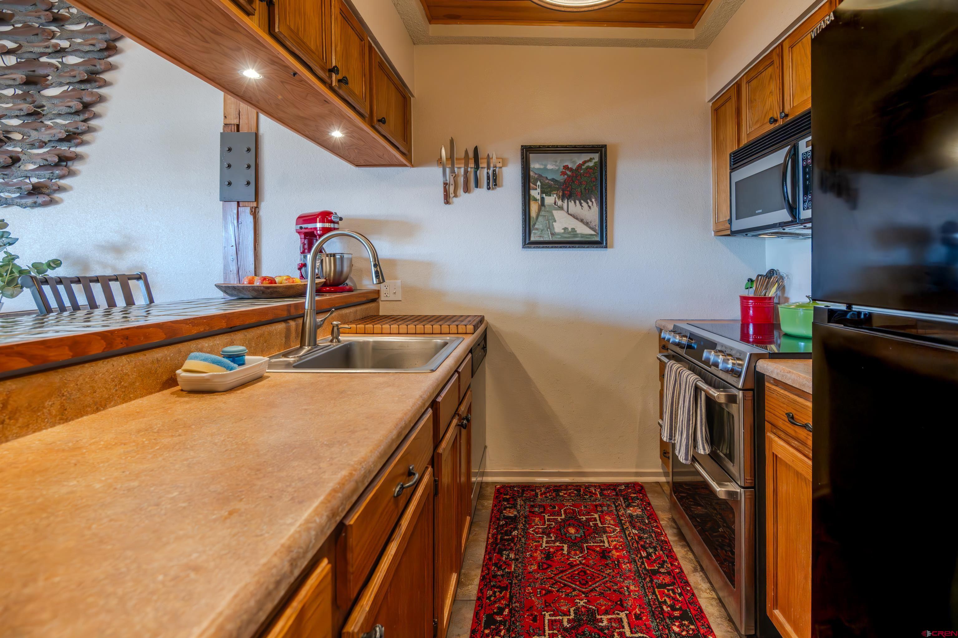 25 Emmons Road, Unit 41 Crested Butte, CO 81225 - Photo 4 of 45 a kitchen with a sink stove and cabinets