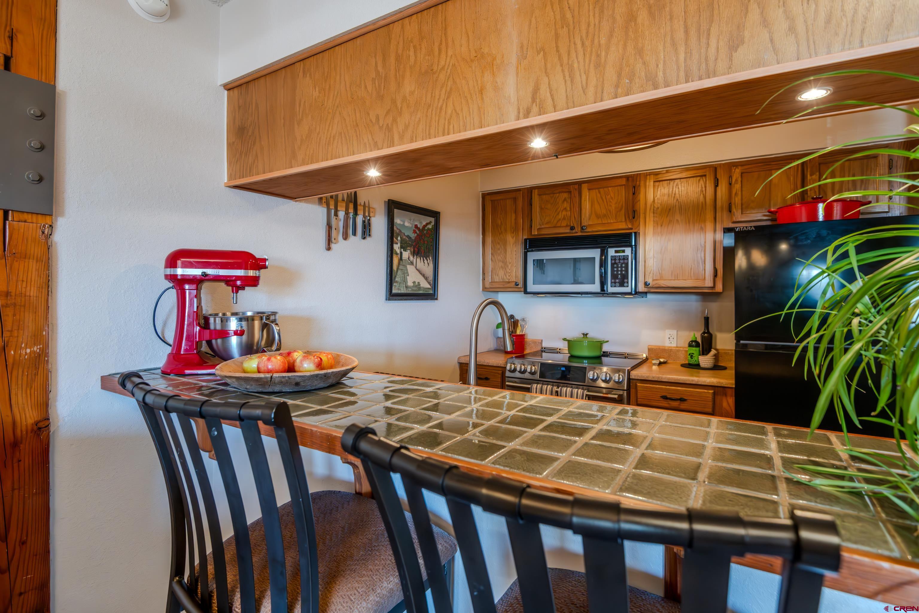 25 Emmons Road, Unit 41 Crested Butte, CO 81225 - Photo 5 of 45 a kitchen with a table chairs stove and cabinets