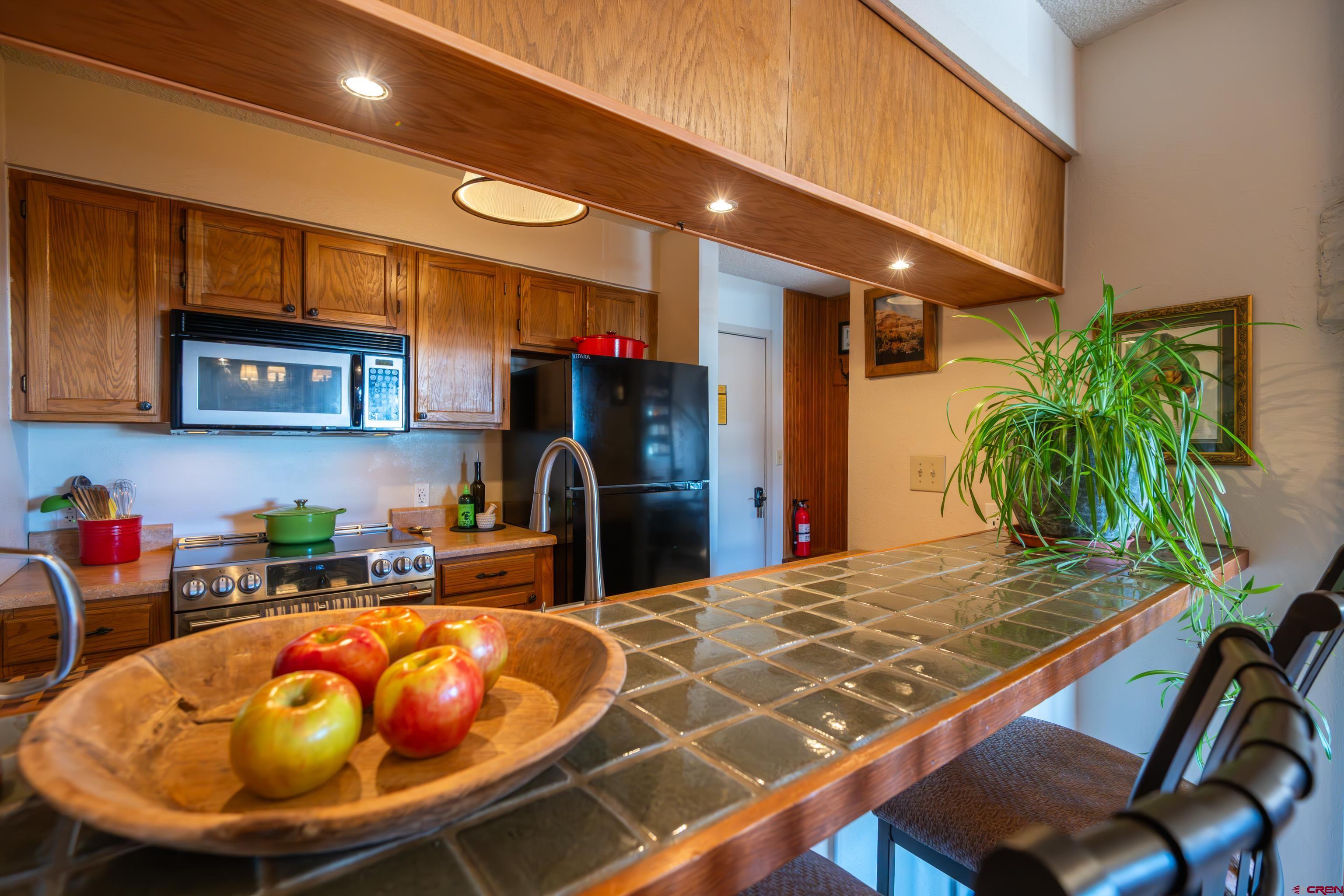 25 Emmons Road, Unit 41 Crested Butte, CO 81225 - Photo 6 of 45 a room with stainless steel appliances kitchen island granite countertop a sink and cabinets
