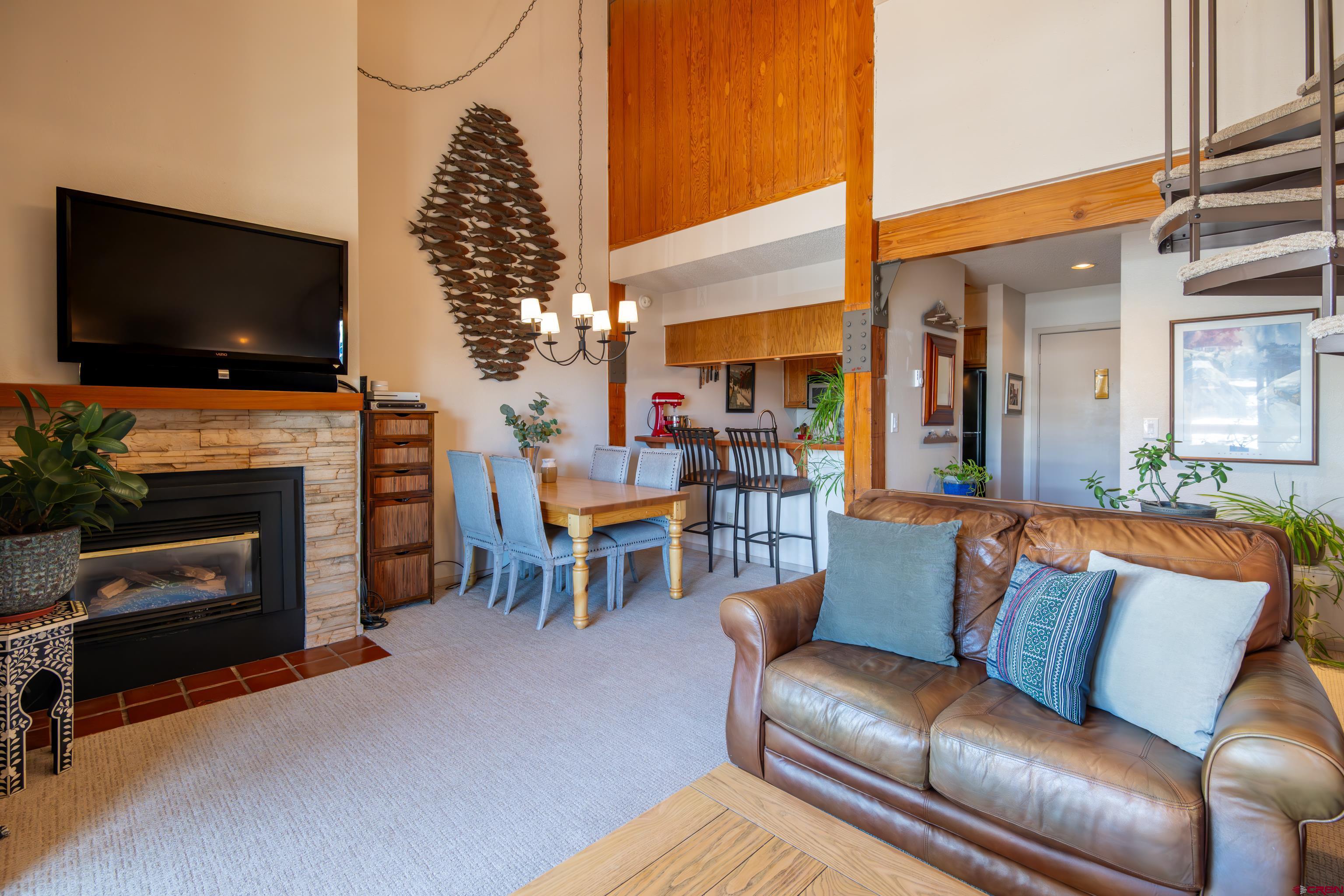 25 Emmons Road, Unit 41 Crested Butte, CO 81225 - Photo 8 of 45 a living room with furniture a flat screen tv and a fireplace