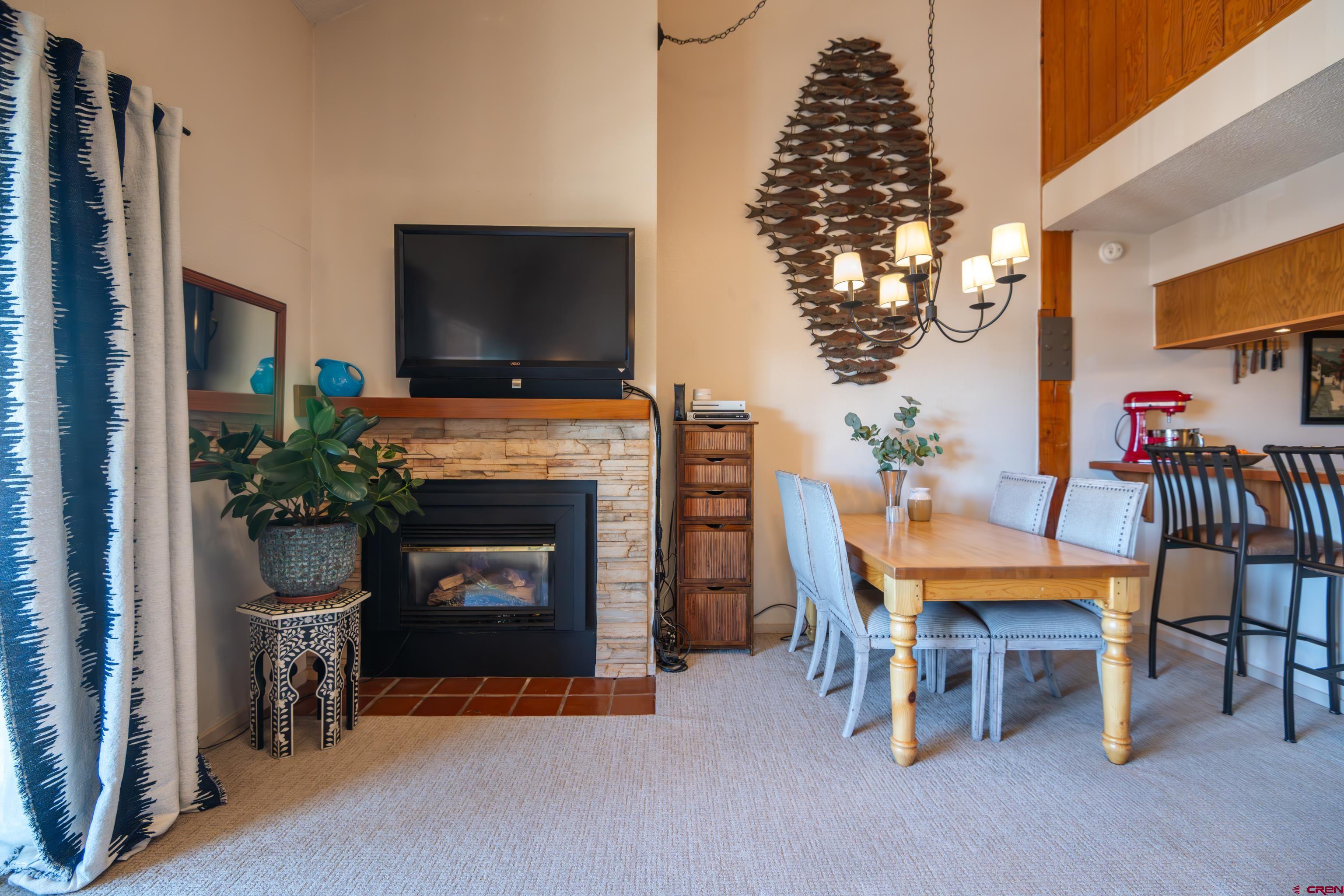 25 Emmons Road, Unit 41 Crested Butte, CO 81225 - Photo 9 of 45 a living room with furniture a flat screen tv and a fireplace