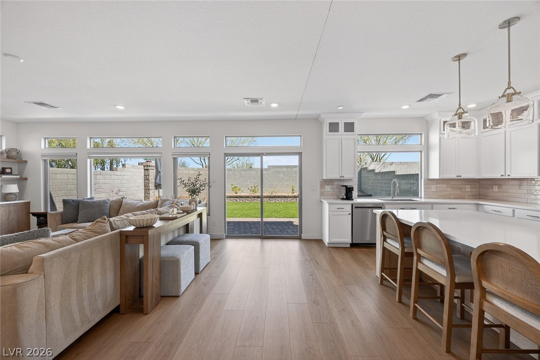 10446 Emerald Rye Street Las Vegas, NV 89183 - Photo 13 of 37 An open-concept living area boasts abundant natural light and seamless access to outdoor recreation.