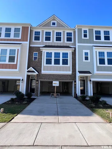 a front view of residential houses with stairs