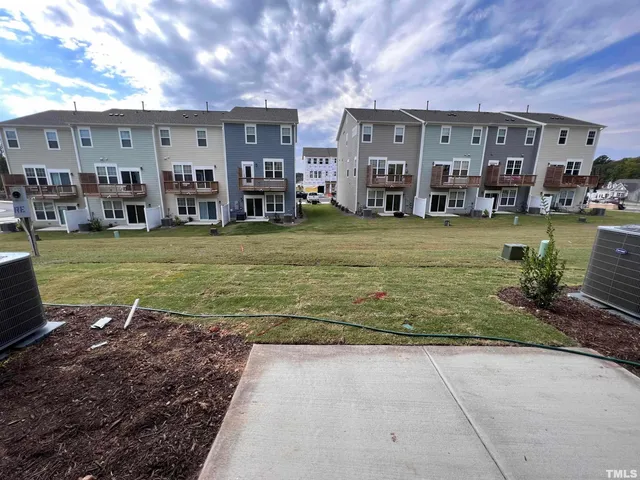 a view of a hallway with wooden floor and windows