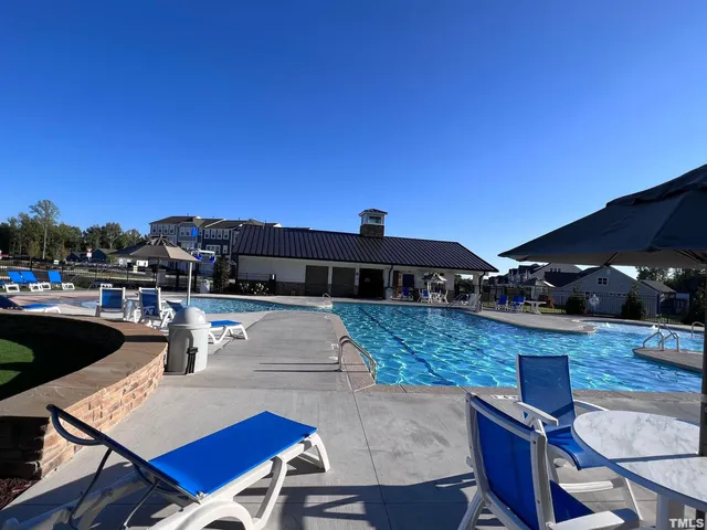 a view of a patio with couches and pool