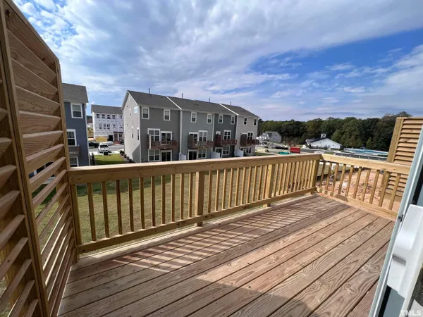 a view of a houses with wooden deck