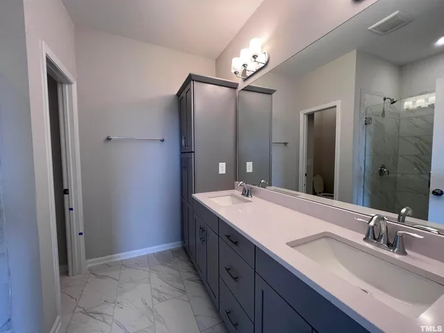 a bathroom with a double vanity sink mirror and double