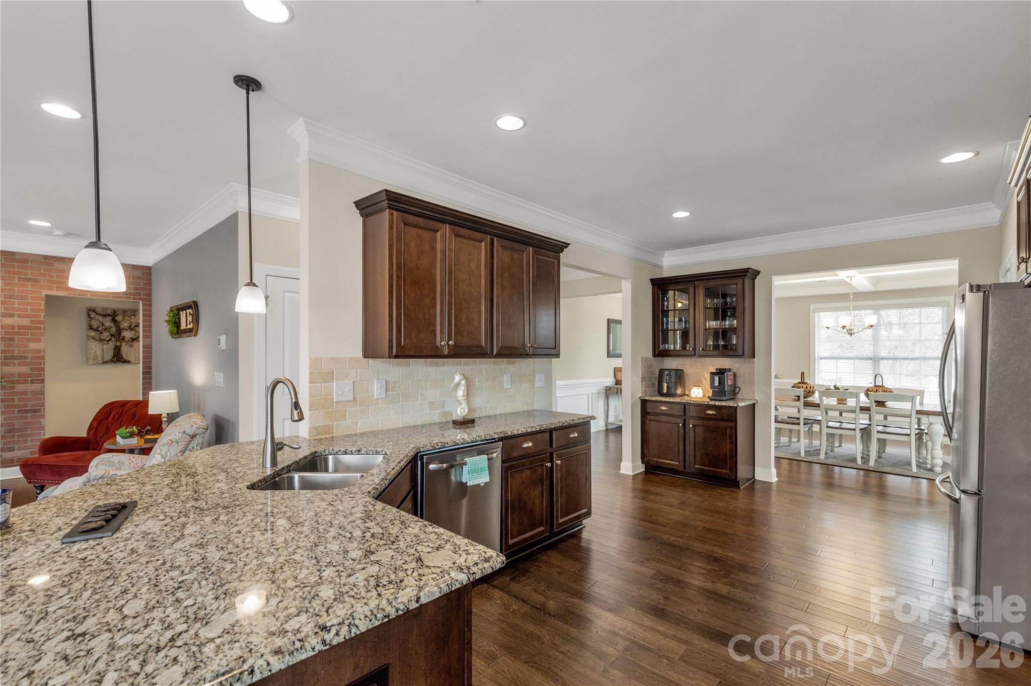 1372 Rainier Drive Fort Mill, SC 29708 - Photo 11 of 48 a kitchen with stainless steel appliances granite countertop sink stove and wooden floor