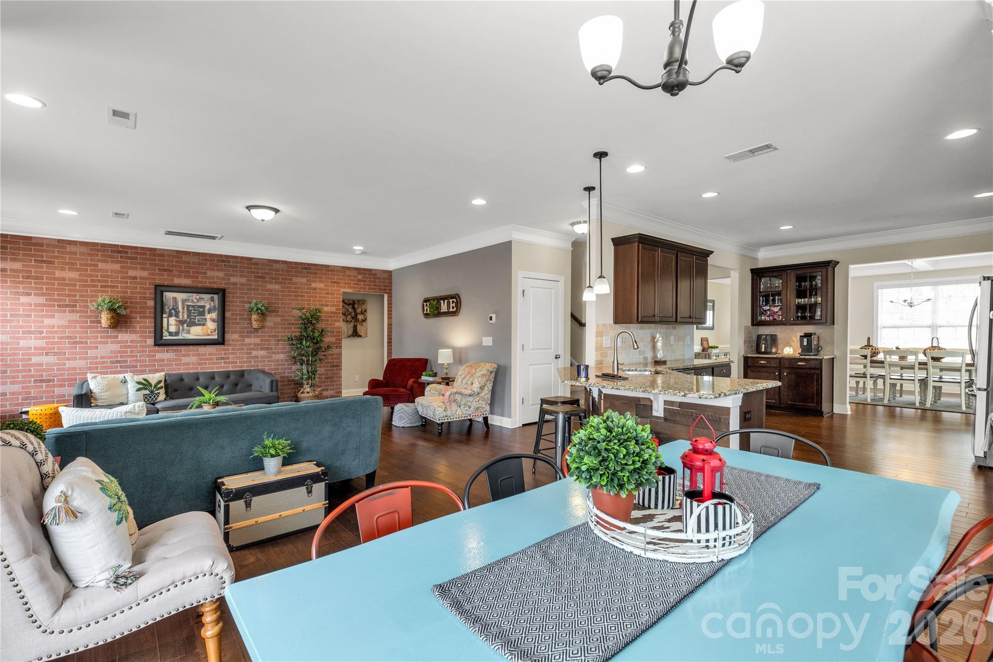 1372 Rainier Drive Fort Mill, SC 29708 - Photo 19 of 48 a living room with furniture kitchen and a chandelier