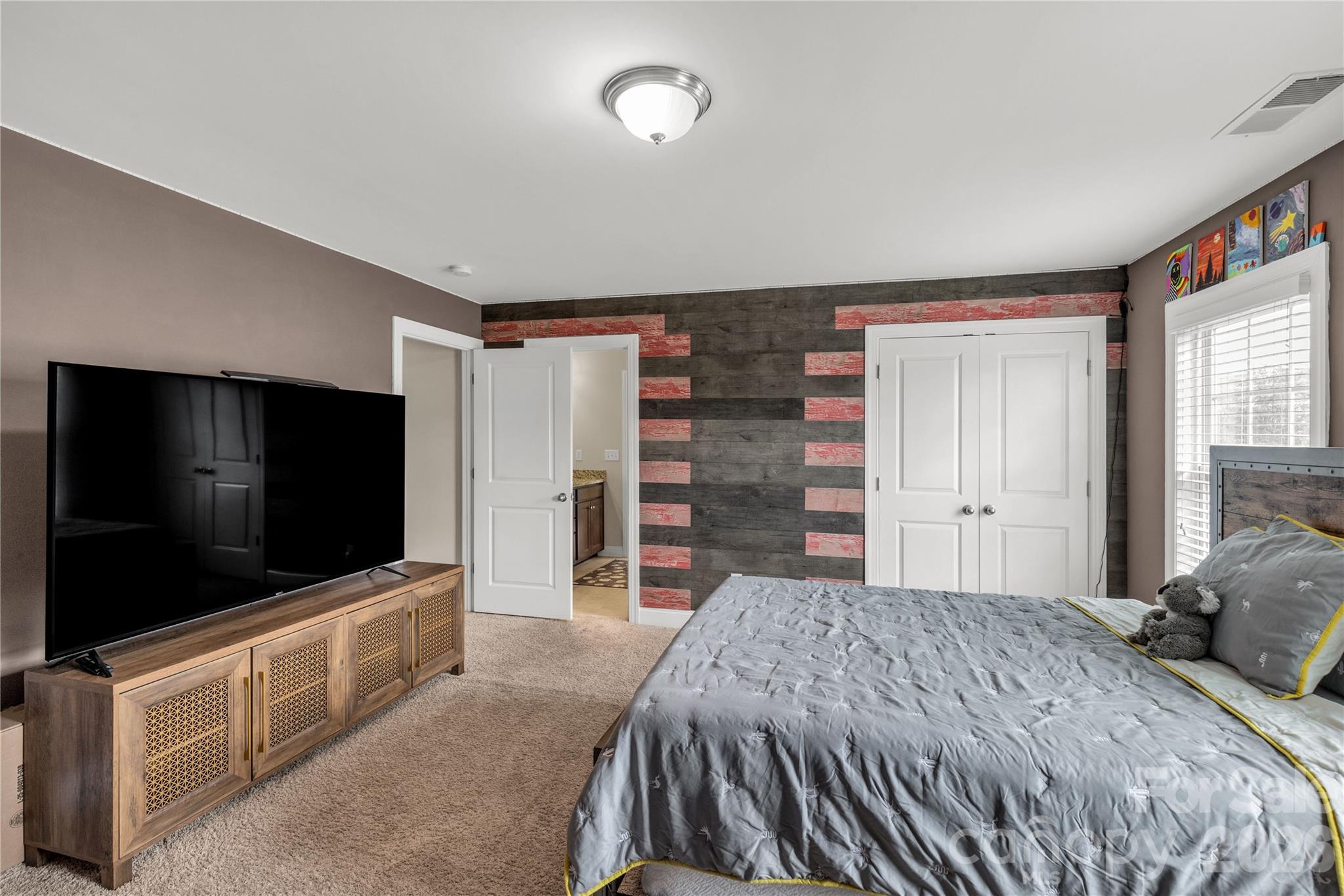 1372 Rainier Drive Fort Mill, SC 29708 - Photo 32 of 48 a bedroom with a bed and a flat screen tv