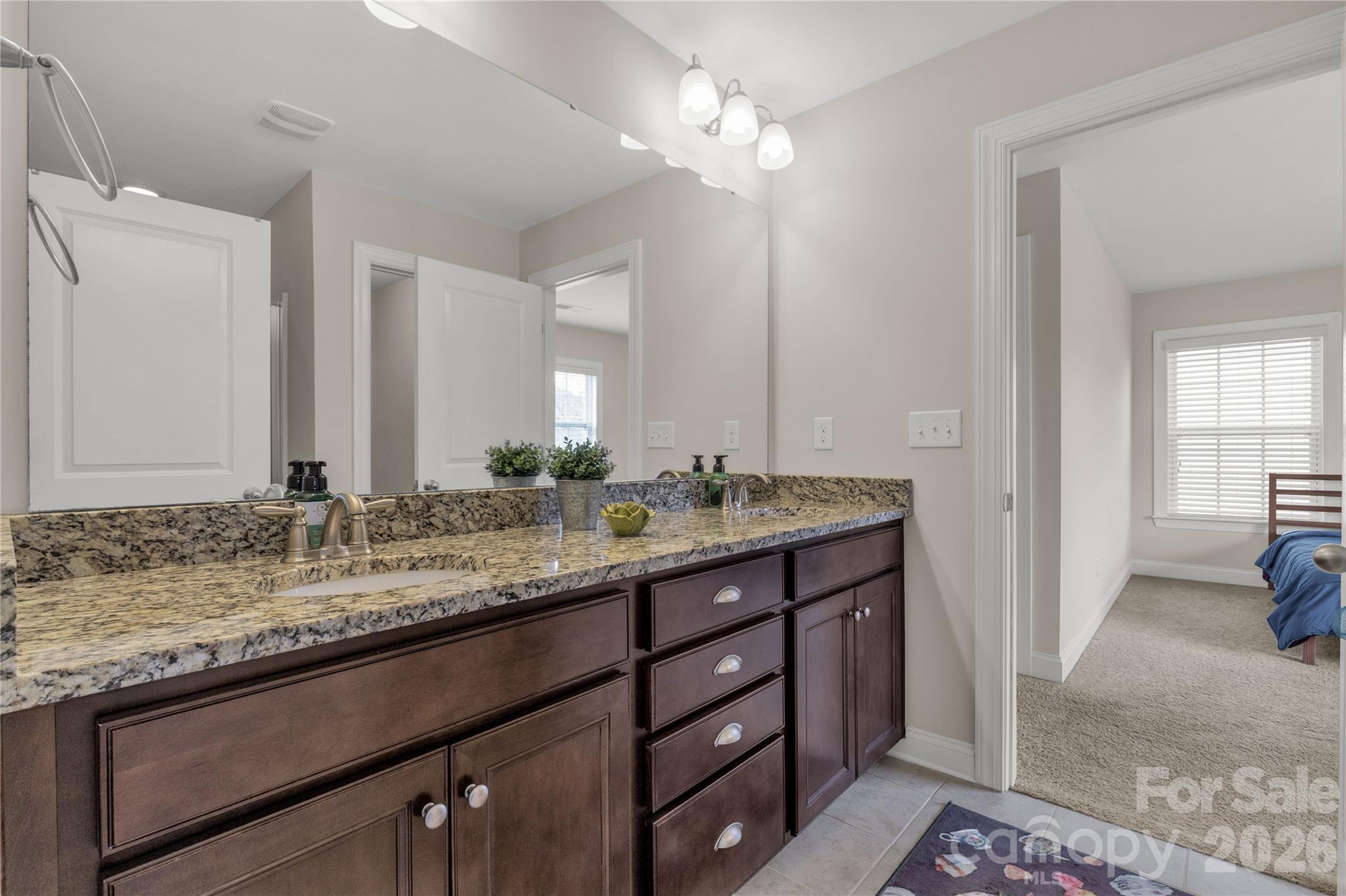 1372 Rainier Drive Fort Mill, SC 29708 - Photo 33 of 48 a bathroom with a granite countertop sink and a mirror
