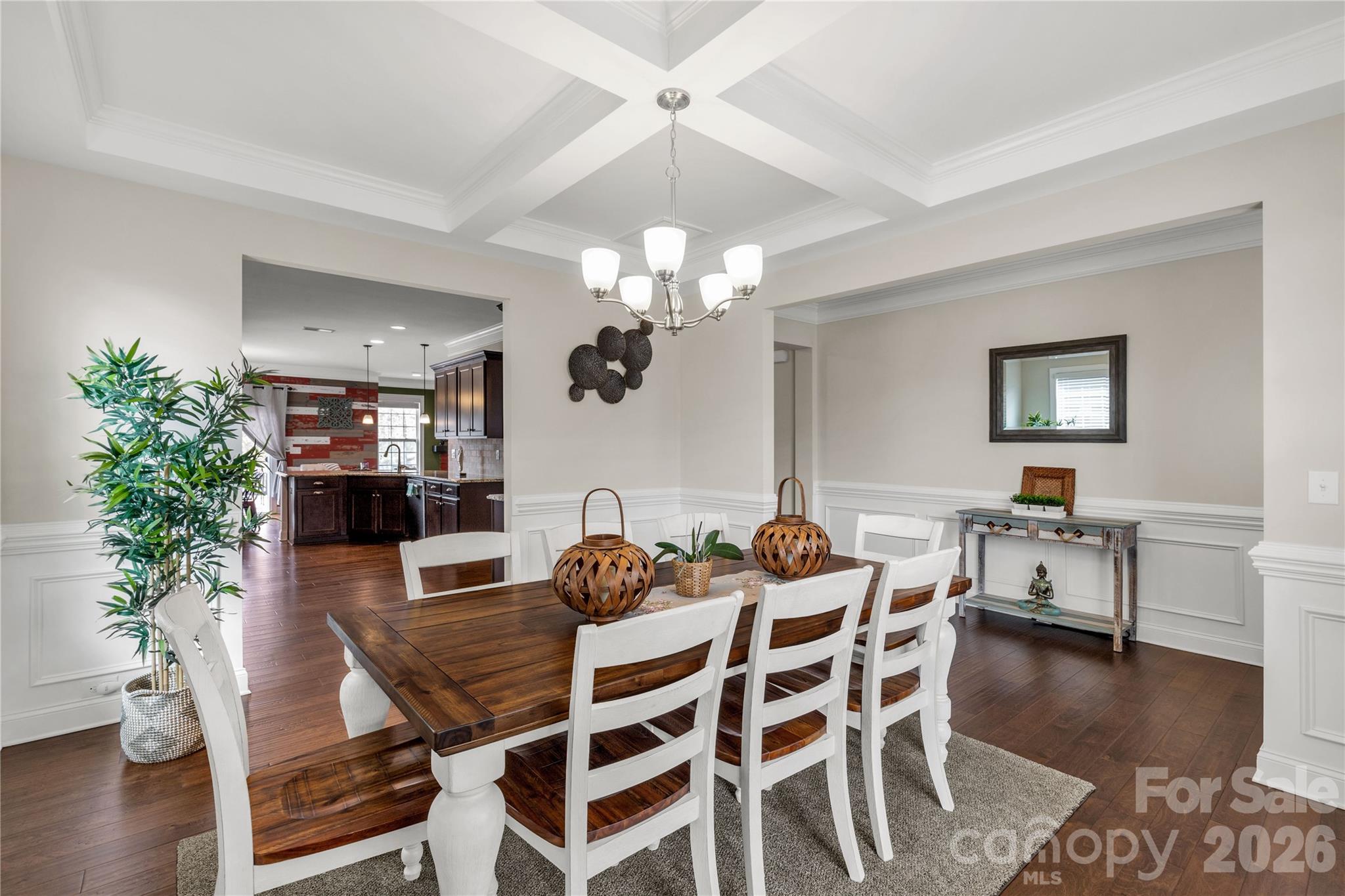 1372 Rainier Drive Fort Mill, SC 29708 - Photo 8 of 48 a dining room with wooden floor a chandelier a glass table and chairs