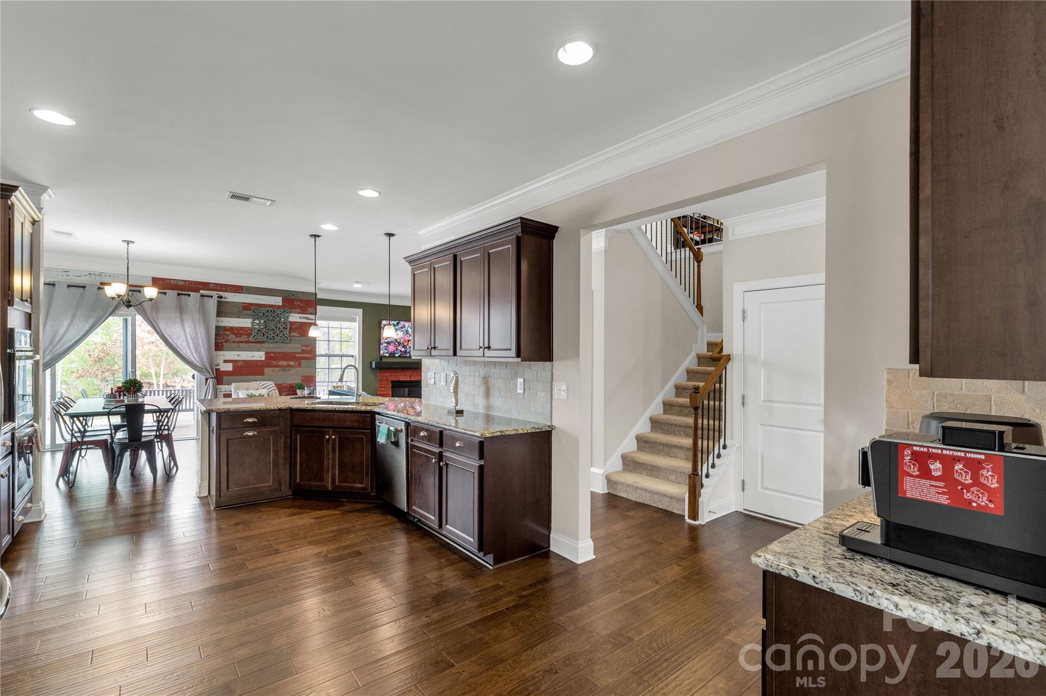 1372 Rainier Drive Fort Mill, SC 29708 - Photo 10 of 48 a open kitchen with lots of wooden furniture and stainless steel appliances